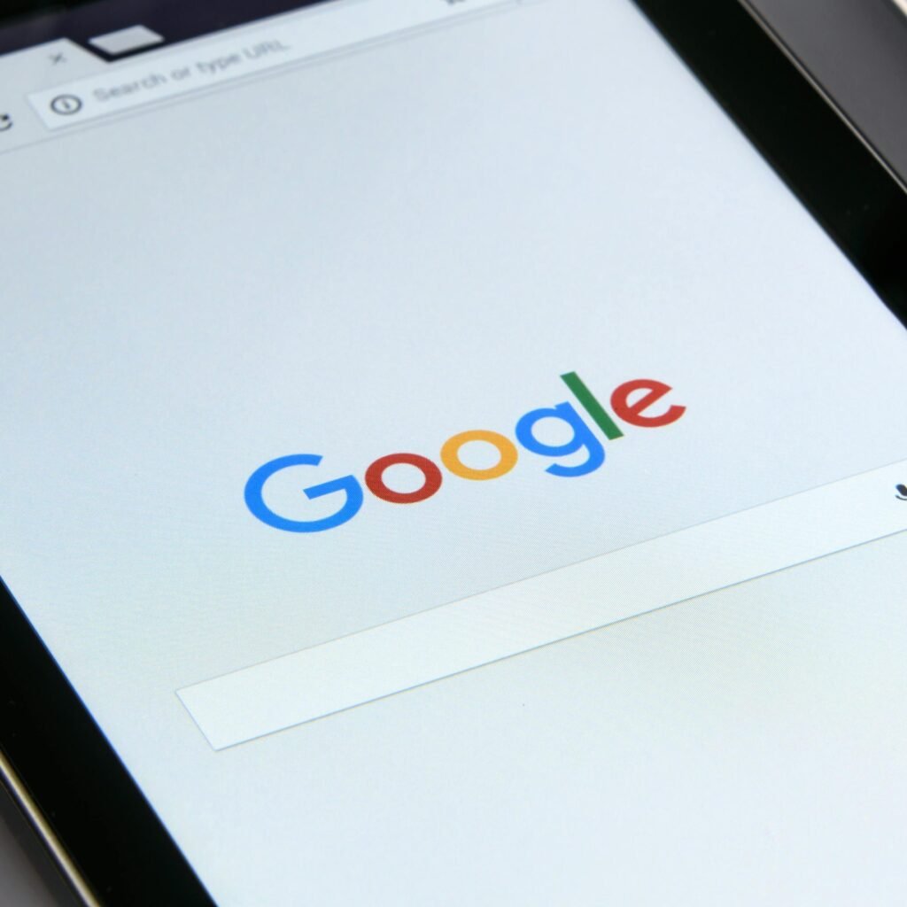 Close-up of a tablet displaying Google's search screen, emphasizing technology and internet browsing.